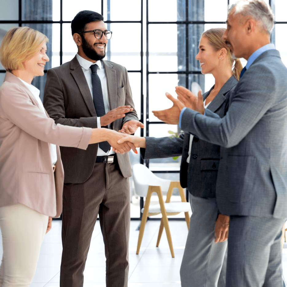 Professional business team handshake in modern office setting